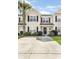 Inviting two-story townhome featuring manicured landscaping and a spacious driveway at 8842 Gable St, North Charleston, SC 29406