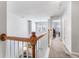 Bright hallway featuring a wooden railing, carpeted floors, and plenty of natural light at 8842 Gable St, North Charleston, SC 29406