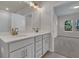 Bathroom featuring a double vanity with modern fixtures and view to bedroom at 930 Dusk Dr, Summerville, SC 29486