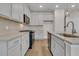 Modern kitchen boasts stainless steel appliances, quartz countertops, designer backsplash, and island at 930 Dusk Dr, Summerville, SC 29486