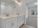 Bright bathroom featuring double vanity with white cabinets, quartz countertop, and elegant fixtures at 960 Dusk Dr, Summerville, SC 29486