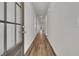 Inviting home hallway featuring wood-look floors and neutral paint tones, leading to sunlit living spaces at 960 Dusk Dr, Summerville, SC 29486