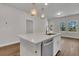 Modern kitchen boasts a central island with stone countertops, pendant lighting, and stainless steel appliances at 960 Dusk Dr, Summerville, SC 29486
