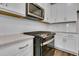 Close-up of the kitchen featuring a stainless steel microwave, gas range, and quartz countertops at 960 Dusk Dr, Summerville, SC 29486