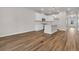 Open-concept living area showcasing an island kitchen, modern lighting, neutral paint, and wood-look flooring at 960 Dusk Dr, Summerville, SC 29486