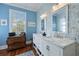 Bathroom featuring double sinks, elegant wallpaper, and a large window at 99 Logan St, Charleston, SC 29401