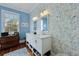 Bathroom with double vanity, unique wallpaper, and hardwood floors at 99 Logan St, Charleston, SC 29401