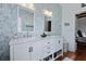 Elegant bathroom featuring double vanity, marble countertop, stylish fixtures, and chic wallpaper at 99 Logan St, Charleston, SC 29401