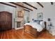 Bedroom with a brick fireplace, hardwood floors, and an antique armoire at 99 Logan St, Charleston, SC 29401