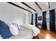 Bright bedroom featuring hardwood floors and natural light from two large windows at 99 Logan St, Charleston, SC 29401