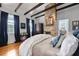 Bedroom featuring exposed wood beams, a brick fireplace, and hardwood floors at 99 Logan St, Charleston, SC 29401