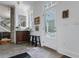 Welcoming entryway featuring tile floors, a dark wood storage cabinet and exposed stone element on a column at 99 Logan St, Charleston, SC 29401