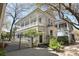 Charming two-story home features a spacious porch, black gate, and beautifully landscaped front yard at 99 Logan St, Charleston, SC 29401
