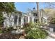 Charming two-story home with grand porch, bay windows, manicured gardens, and iron gate at 99 Logan St, Charleston, SC 29401