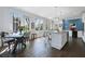 Sun-drenched kitchen featuring a granite island, stainless appliances, and a wall of windows overlooking the backyard at 99 Logan St, Charleston, SC 29401