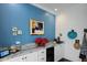 Close up of kitchen bar featuring granite countertops, wine fridge, mini fridge and a brightly painted wall at 99 Logan St, Charleston, SC 29401