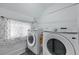 Efficient laundry room with Samsung washer and dryer units, and functional window at 99 Logan St, Charleston, SC 29401