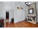 Home office with hardwood floors, a brick fireplace, and built in shelves at 99 Logan St, Charleston, SC 29401