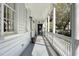 Charming porch with white columns, a wood-paneled ceiling, and a view of the front yard at 99 Logan St, Charleston, SC 29401