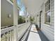 Charming covered front porch with traditional white columns and gray flooring at 99 Logan St, Charleston, SC 29401