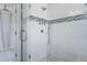 Tiled shower with glass doors and mosaic tile accent stripe at 99 Logan St, Charleston, SC 29401