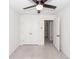 A bright bedroom with neutral carpet, ceiling fan, and white doors to closet and hallway at 103 Rosa Gray Ln, Goose Creek, SC 29445