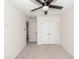 A bright bedroom with neutral carpet, ceiling fan, and white doors to closet and hallway at 103 Rosa Gray Ln, Goose Creek, SC 29445