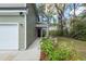 A close-up of the home's front door, with a view of the walkway lined with flowering shrubs at 103 Rosa Gray Ln, Goose Creek, SC 29445