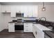 Well-lit kitchen featuring white cabinets, stainless steel appliances, and black countertops at 103 Rosa Gray Ln, Goose Creek, SC 29445
