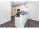 Open concept view showcasing kitchen with stainless appliances, granite countertops, bar seating and luxury vinyl plank flooring at 103 Rosa Gray Ln, Goose Creek, SC 29445