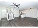 Spacious open-concept living room and kitchen area with staircase, and luxury vinyl plank flooring at 103 Rosa Gray Ln, Goose Creek, SC 29445