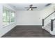 Bright living room showcasing hardwood floors, a modern ceiling fan, and a staircase at 103 Rosa Gray Ln, Goose Creek, SC 29445