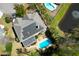 Aerial view of a beautiful home with a pool, solar panels and pond at 1067 Shipton Ct, Charleston, SC 29414