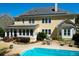 Beautiful backyard with a pool, stone deck, solar panels and a yellow house at 1067 Shipton Ct, Charleston, SC 29414