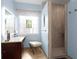 Bathroom showcases a vanity with a frosted window and walk-in shower with decorative tile at 1067 Shipton Ct, Charleston, SC 29414