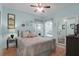 Bedroom with light blue walls, ceiling fan, and a large bed with patterned comforter at 1067 Shipton Ct, Charleston, SC 29414
