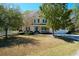 Charming two-story home with a well-manicured lawn, mature trees, and an inviting front porch at 1067 Shipton Ct, Charleston, SC 29414