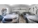 A two-car garage features an automatic door and houses two modern cars at 1067 Shipton Ct, Charleston, SC 29414
