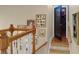 Upstairs hallway with wood railing, decorative wall art, and access to the theater room at 1067 Shipton Ct, Charleston, SC 29414
