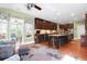Open kitchen showcases ample dark wood cabinetry, a large island with seating, and hardwood floors at 1067 Shipton Ct, Charleston, SC 29414