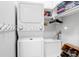 Bright laundry room with modern washer and dryer, storage cabinets, and a shoe rack at 1067 Shipton Ct, Charleston, SC 29414