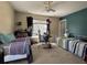 This bedroom features two beds, a ceiling fan, and a large window providing natural light at 111 Spanish Oak Ln, Ladson, SC 29456