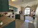 Kitchen with blue cabinets, appliances, view of living room, and lots of natural light at 111 Spanish Oak Ln, Ladson, SC 29456