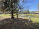 Scenic view of the calm pond with a fountain surrounded by lush greenery and trees at 111 Spanish Oak Ln, Ladson, SC 29456