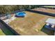 Aerial view of a fenced backyard with pool, playset, and covered patio at 112 Lois Cir, Moncks Corner, SC 29461
