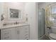 Charming bathroom with white plank accent wall, granite counters, shower, and toilet at 112 Lois Cir, Moncks Corner, SC 29461