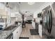 Bright, modern kitchen with stainless steel appliances and an open view into the living room at 112 Lois Cir, Moncks Corner, SC 29461
