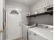 Well-organized laundry room features washer, dryer, storage shelf, and an exterior door at 112 Lois Cir, Moncks Corner, SC 29461
