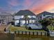 Backyard view of the home with a screened porch, wooden deck, and waterfront access at 1124 Clearspring Dr, Charleston, SC 29412