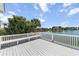 The deck overlooks a tranquil lake with mature trees and landscaping to enhance the peaceful outdoor setting at 1124 Clearspring Dr, Charleston, SC 29412